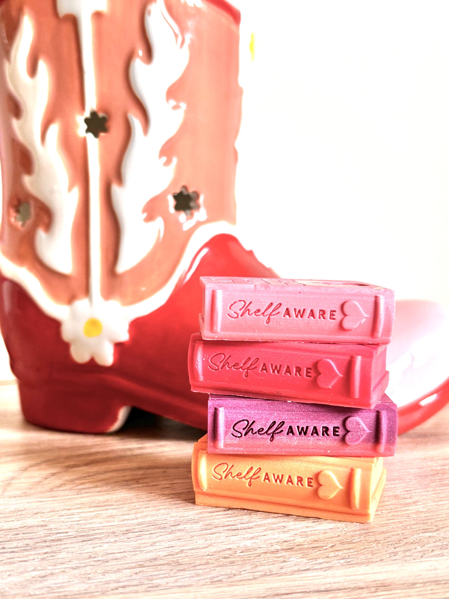 book wax melts in a stack with cowboy boot burner