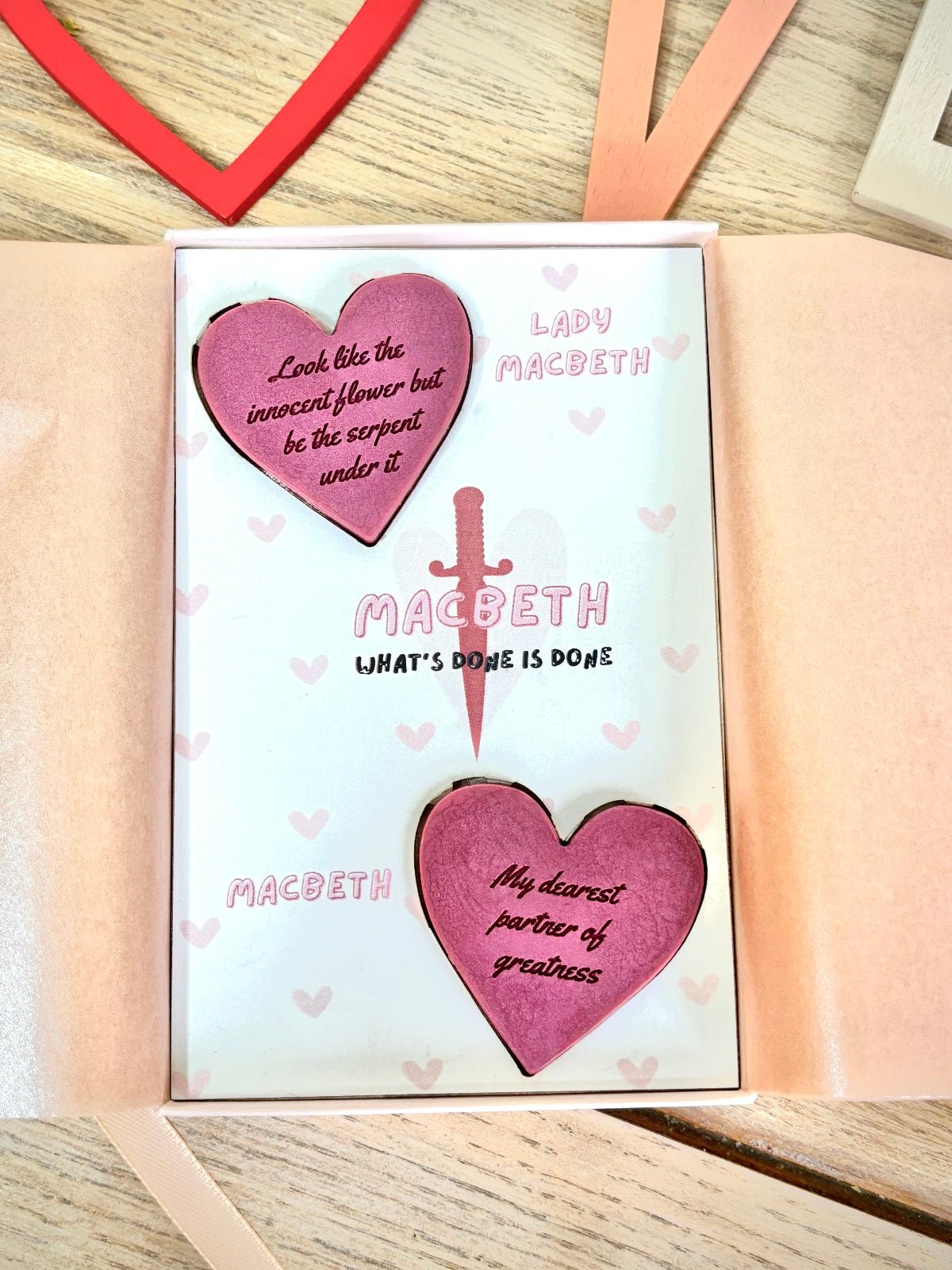 macbeth wax melts for book lovers in a pink gift box. two wax melts with quotes on them from macbeth and lady macbeth. gifts for classic book lovers and shakespeare. look like the innocent flower but be the serpent under it quote on a wax melt.