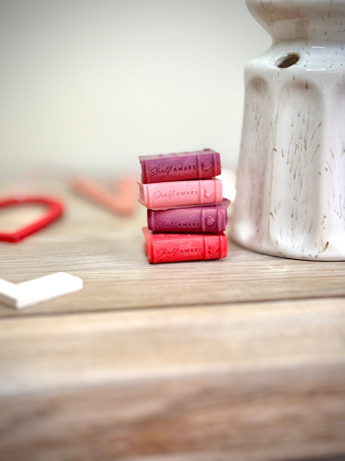 wax melts for book lovers with a valentines theme. 4 book shaped wax melts, each one pays homage to romance novels in a pink gift box. fun and feminine wax melt gifts for book lovers. 